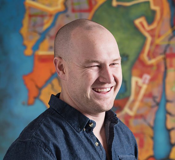 Artist Ben Joyce paints on a canvas